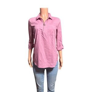 Emily Daniel’s women's pink collared shirt with a half-zip neckline and two ches